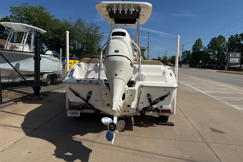 Slide: The Image of 2017 Key West 219 FS boat with outboard motor, parked on a sunny day. - 14