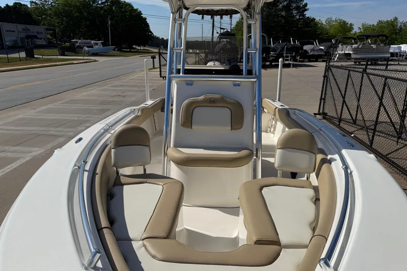 Slide: The Image of 2017 Key West 219 FS boat with beige seating, docked on a sunny day. - 16