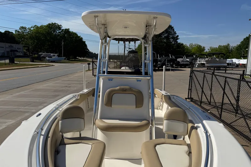 Slide: The Image of 2017 Key West 219 FS boat with seating, parked on a sunny day. - 17