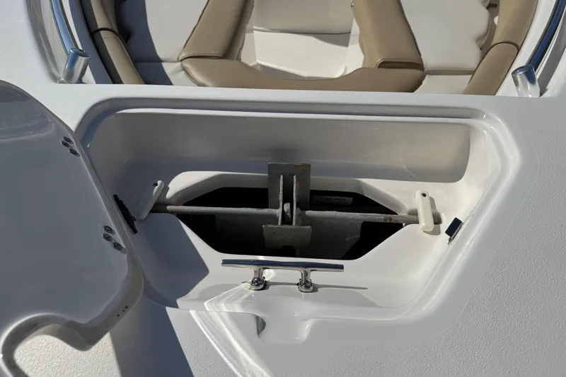 Slide: The Image of Anchor storage compartment on a 2017 Key West 219 FS boat, featuring beige seating. - 19
