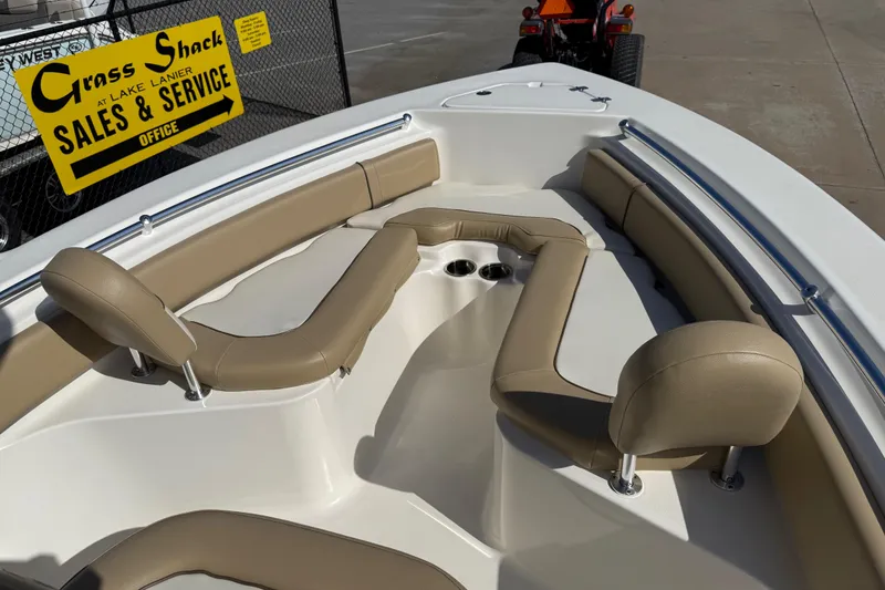 Slide: The Image of 2017 Key West 219 FS boat interior with tan seating, displayed at sales office. - 20