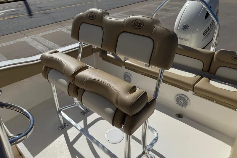 Slide: The Image of 2017 Key West 219 FS boat interior with tan seating and Suzuki engine. - 28