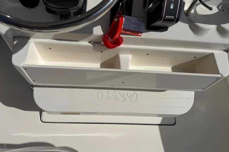 Slide: The Image of 2017 Key West 219 FS boat console with storage compartments and Suzuki controls. - 31