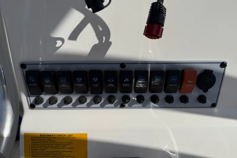 Slide: The Image of Control panel of a 2017 Key West 219 FS boat with labeled switches. - 33