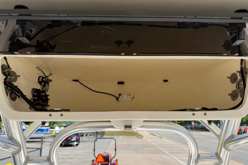 Slide: The Image of Open electronics compartment of 2017 Key West 219 FS boat, showing wiring and components. - 37