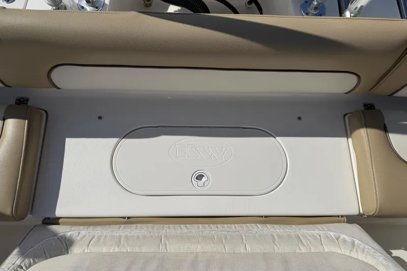 Slide: The Image of 2017 Key West 219 FS boat interior with beige seating and storage compartment. - 42