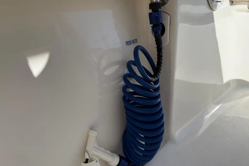 Slide: The Image of Coiled blue hose labeled "Fresh Water" on 2017 Key West 219 FS boat. - 44