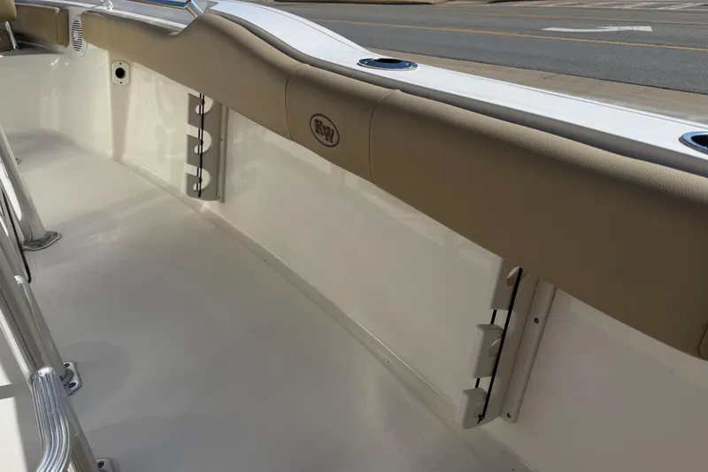 Slide: The Image of 2017 Key West 219 FS boat interior with beige upholstery and rod holders. - 46
