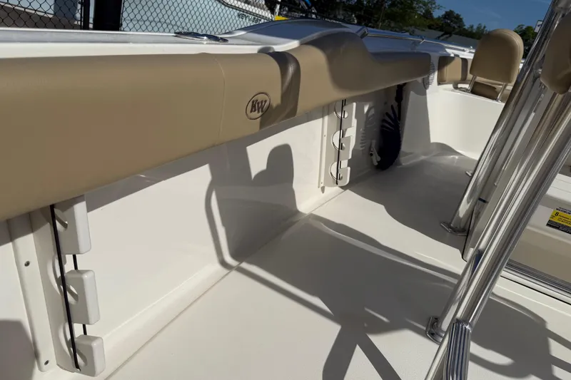 Slide: The Image of 2017 Key West 219 FS boat interior with beige seating and stainless steel fixtures. - 47