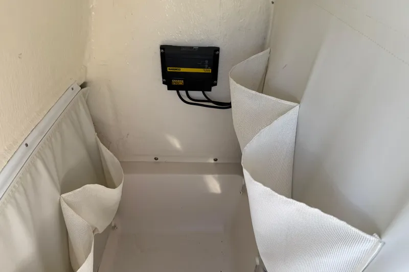 Slide: The Image of 2017 Key West 219 FS boat interior with Marinko electrical panel and storage compartment. - 49