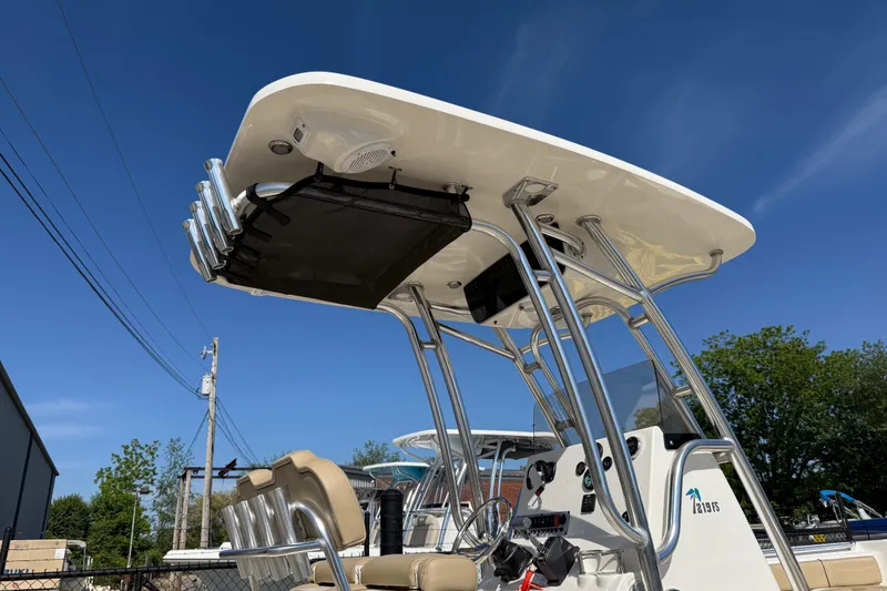 Slide: The Image of 2017 Key West 219 FS boat with T-top and rod holders under clear blue sky. - 50