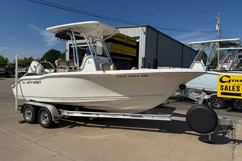 The Image of 2017 Key West 219 FS boat on trailer at dealership, sunny day. - 9