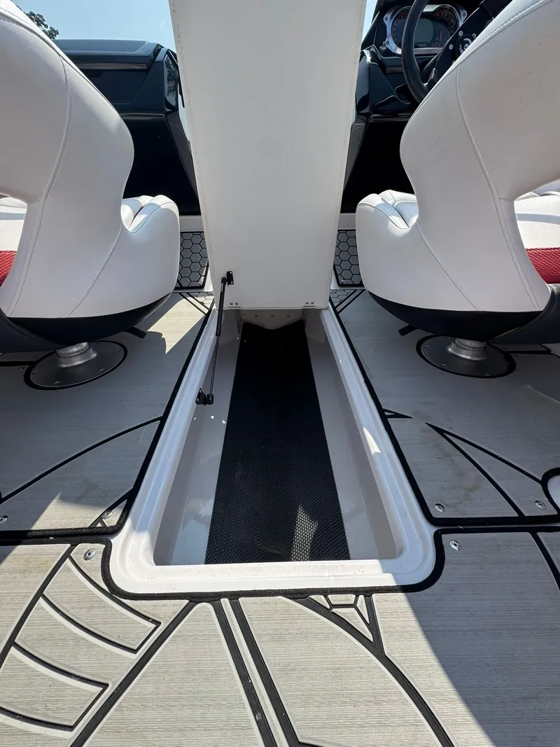 Slide: The Image of Interior of a 2018 Scarab 215 ID boat with white seats. - 12