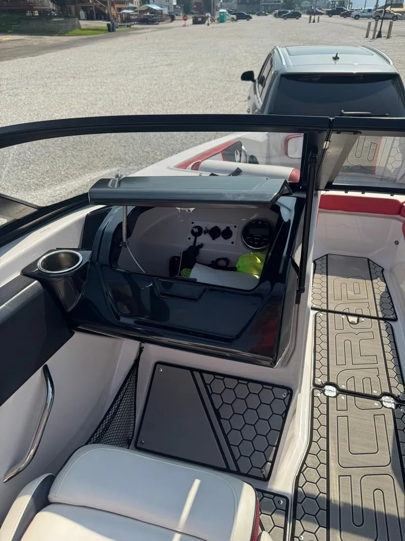 Slide: The Image of Interior of a 2018 Scarab 215 ID boat with cockpit details. - 13