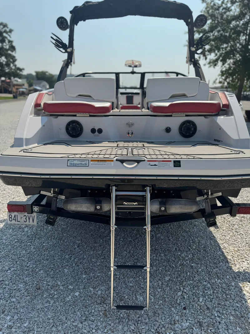 Slide: The Image of Rear view of a 2018 Scarab 215 ID boat with ladder. - 14