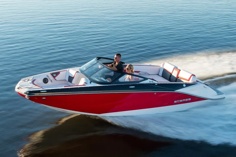 Slide: The Image of 2018 Scarab 215 ID boat cruising on calm water. - 24