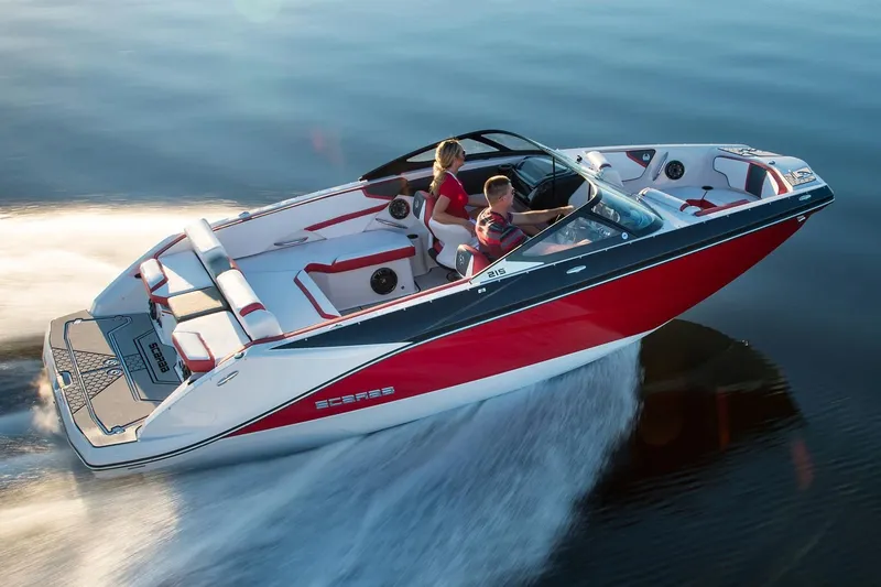 Slide: The Image of 2018 Scarab 215 ID boat cruising on calm water. - 25