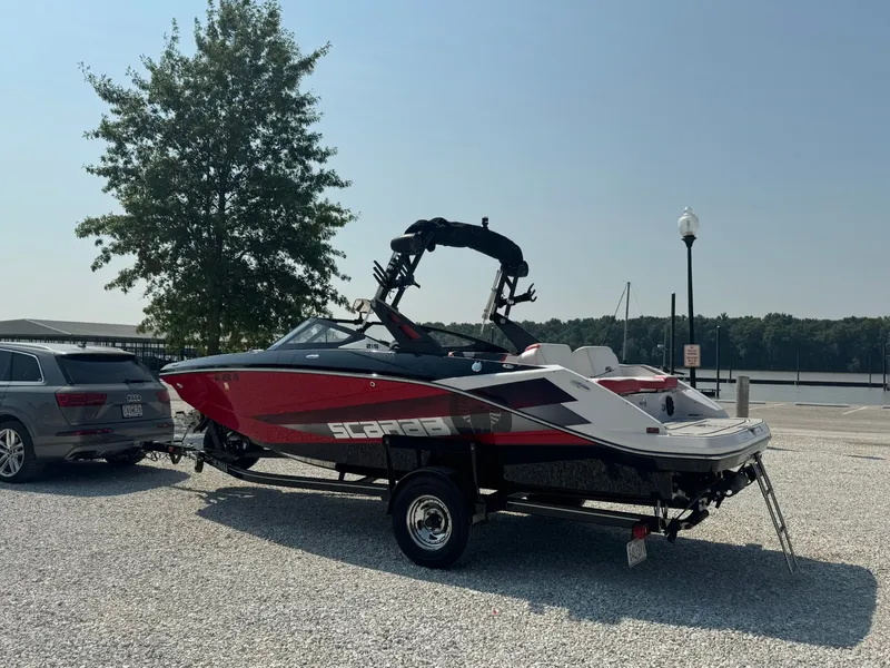 Slide: The Image of 2018 Scarab 215 ID boat on trailer by lakeside. - 4