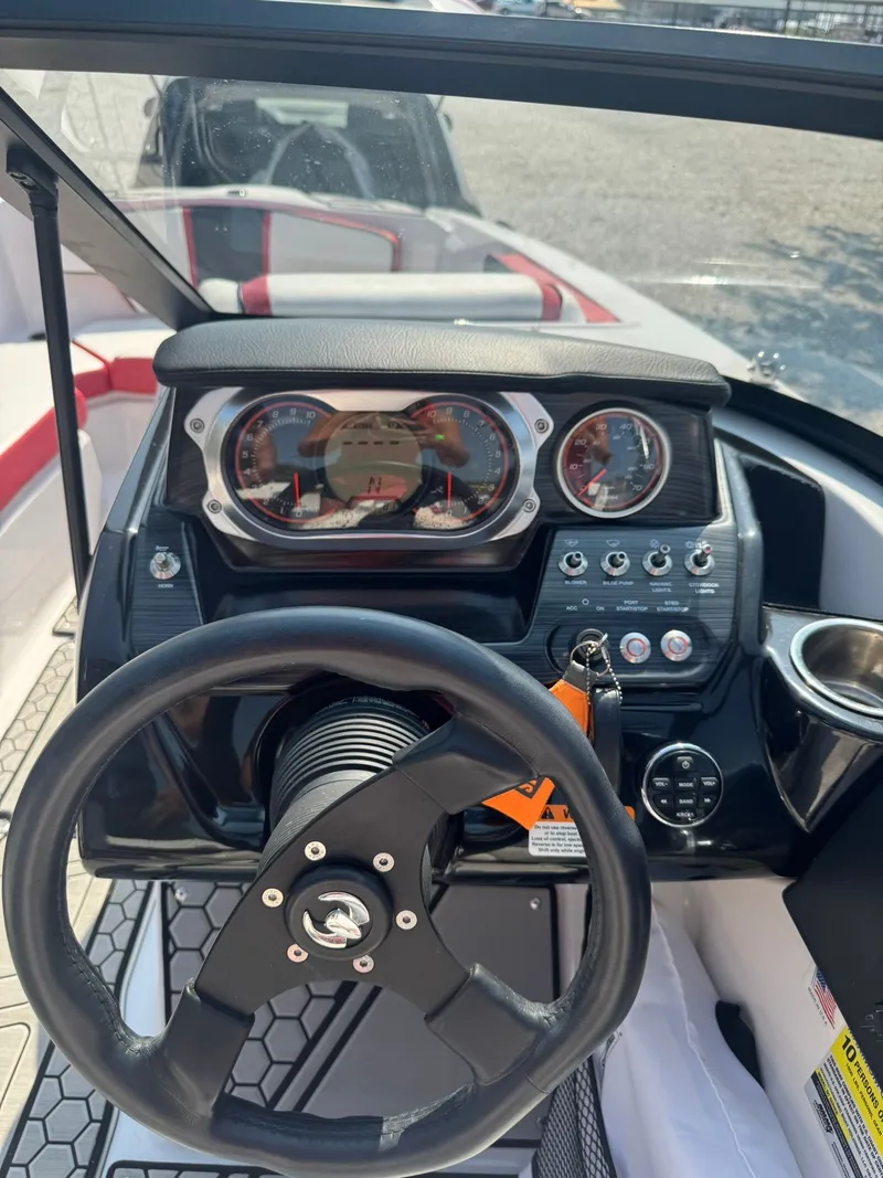 Slide: The Image of Dashboard of a 2018 Scarab 215 ID boat with steering wheel. - 6