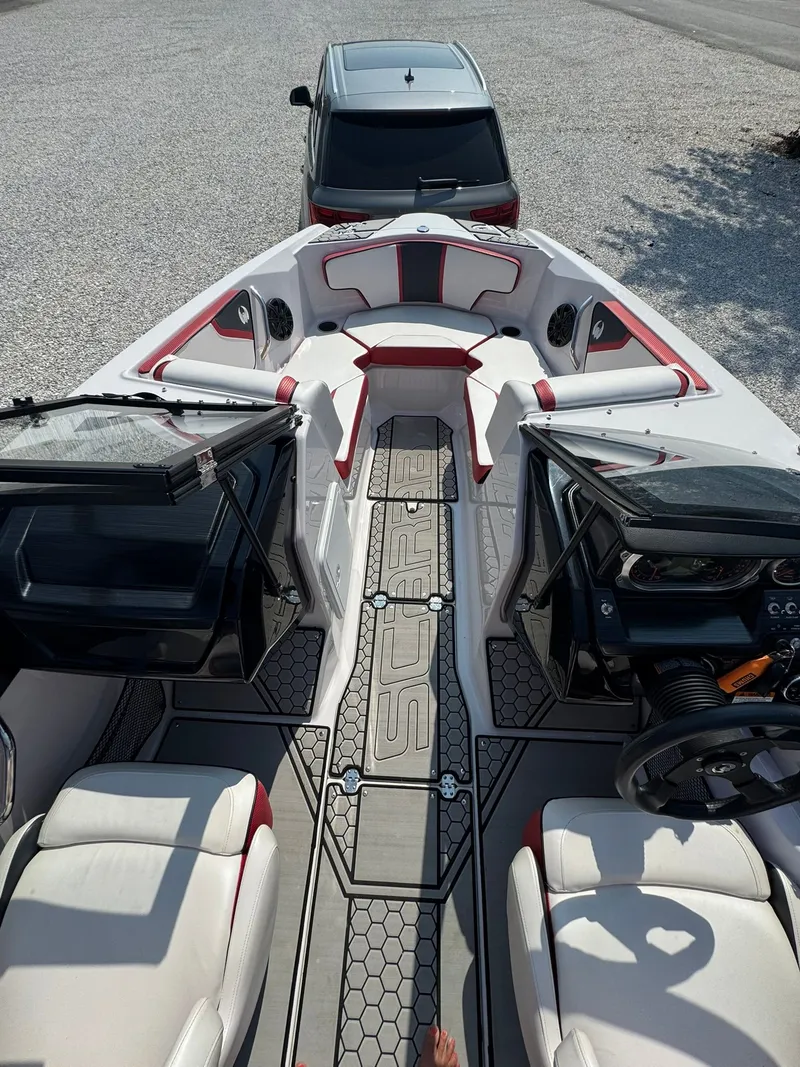 Slide: The Image of Interior view of a 2018 Scarab 215 ID boat with luxurious seating. - 8