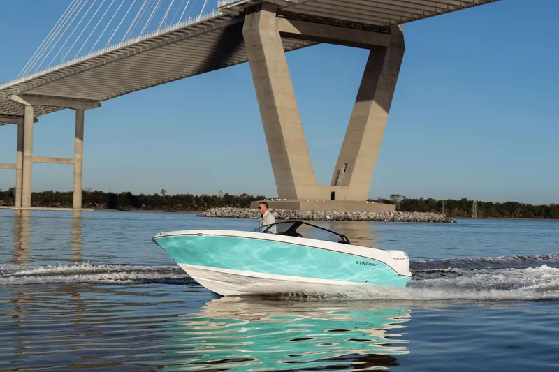 Slide: The Image of 2026 Stingray 20 SBX boat under bridge on calm water. - 17