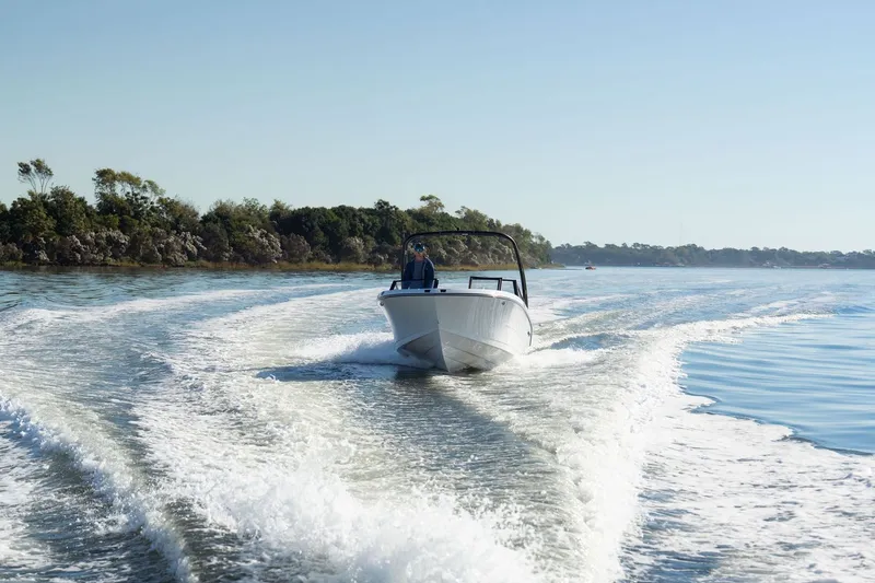 Slide: The Image of 2026 Stingray 20 SBX boat cruising on calm waters. - 18