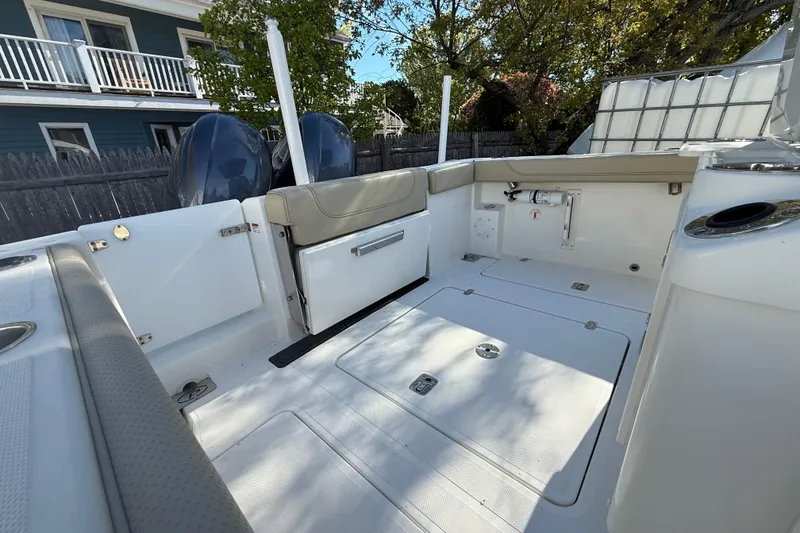 Slide: The Image of 2021 Pursuit S 268 Sport boat interior with dual engines and seating area. - 10