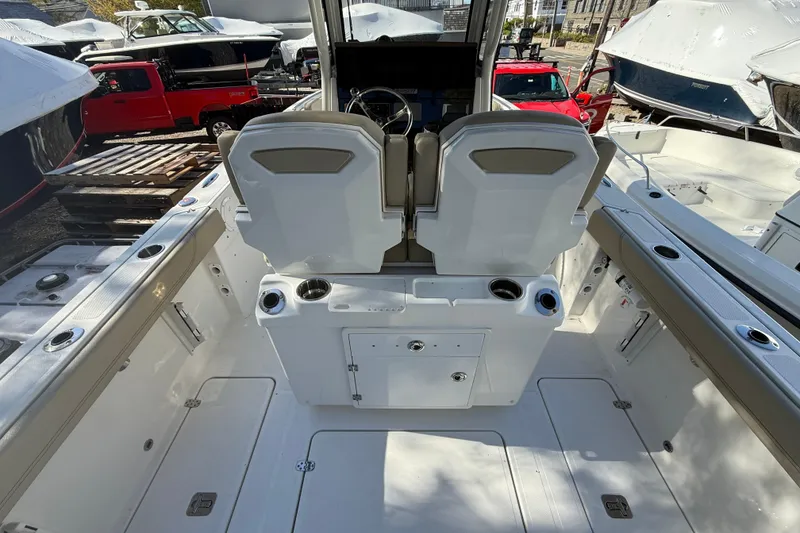 Slide: The Image of 2021 Pursuit S 268 Sport boat interior with dual seats and storage compartments. - 11