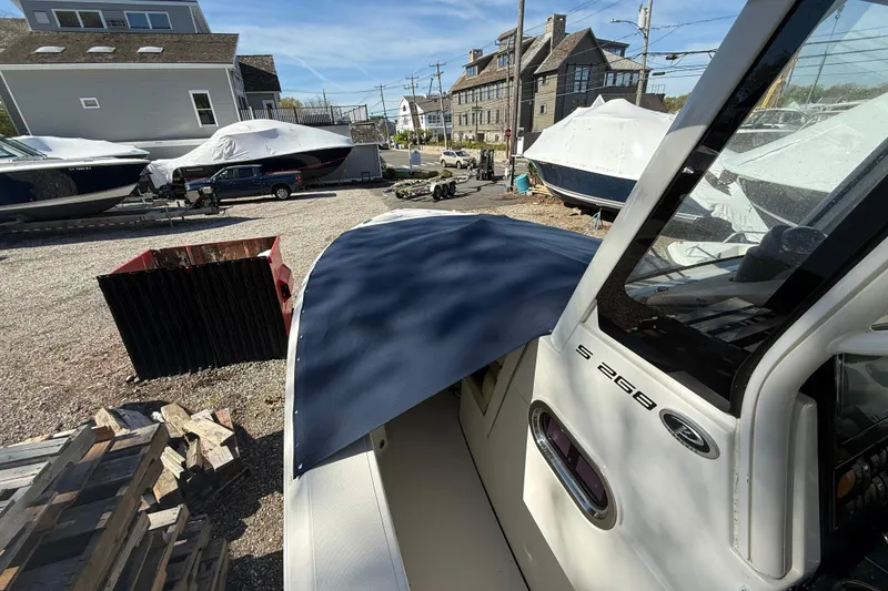 Slide: The Image of 2021 Pursuit S 268 Sport boat in a marina storage area. - 14