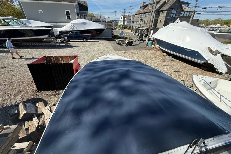 Slide: The Image of 2021 Pursuit S 268 Sport boat covered in a marina storage area. - 15