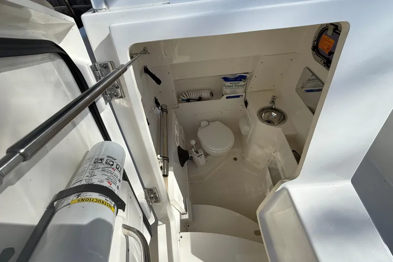 Slide: The Image of Interior view of 2021 Pursuit S 268 Sport boat's compact bathroom area. - 16