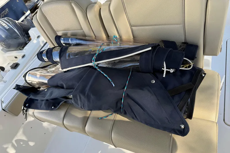 Slide: The Image of Folded boat cover on Pursuit S 268 Sport 2021's beige seating. - 17