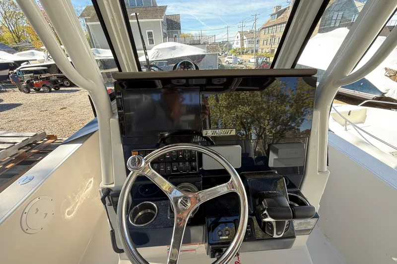 Slide: The Image of 2021 Pursuit S 268 Sport boat dashboard with steering wheel and controls. - 6
