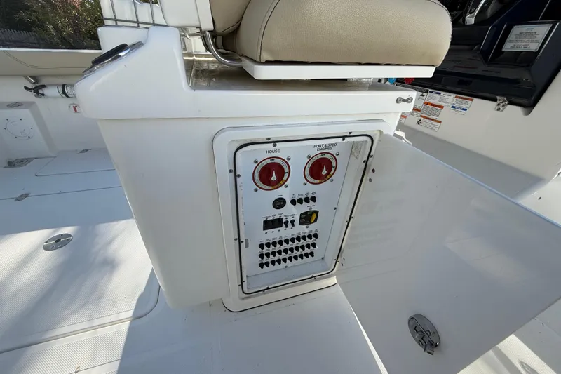Slide: The Image of Control panel on a 2021 Pursuit S 268 Sport boat, featuring switches and dials. - 7