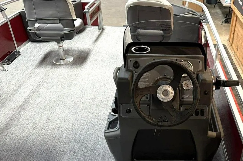 Slide: The Image of 2026 Sun Tracker Bass Buggy 18 DLX interior with steering console and seating. - 2