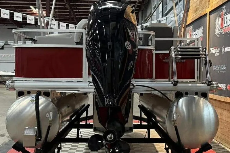 Slide: The Image of 2026 Sun Tracker Bass Buggy 18 DLX pontoon boat with outboard motor in showroom. - 4