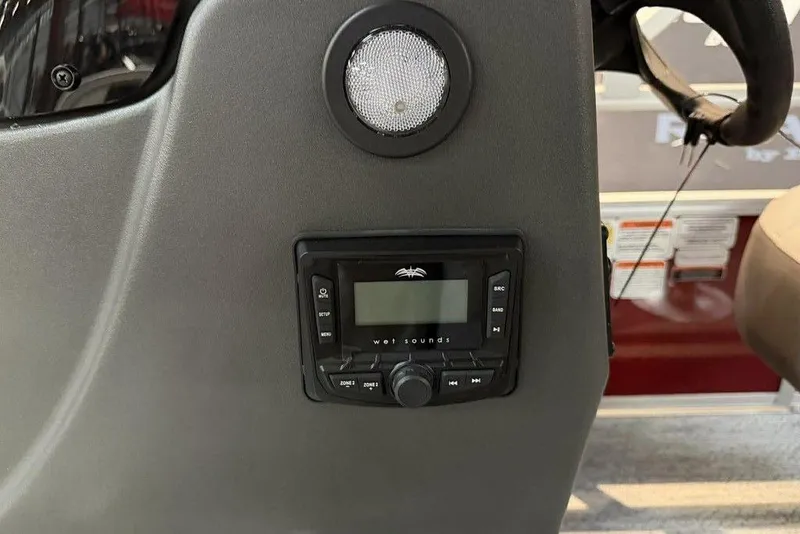 Slide: The Image of 2026 Sun Tracker Bass Buggy 18 DLX dashboard with audio system and speaker. - 7
