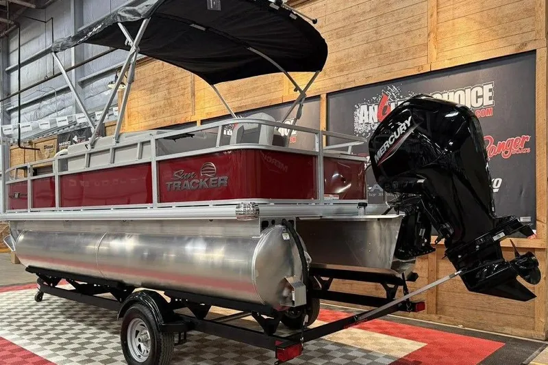 Slide: The Image of 2026 Sun Tracker Bass Buggy 18 DLX pontoon boat with Mercury engine in showroom. - 8