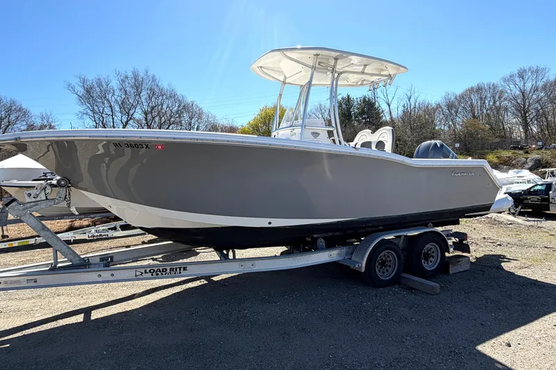 The Image of 2015 Tidewater 230 CC Adventure boat on trailer under clear blue sky. - 0