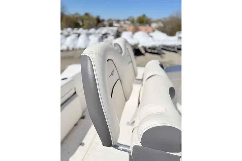 Slide: The Image of 2015 Tidewater 230 CC Adventure boat seat with gray and white upholstery. - 11