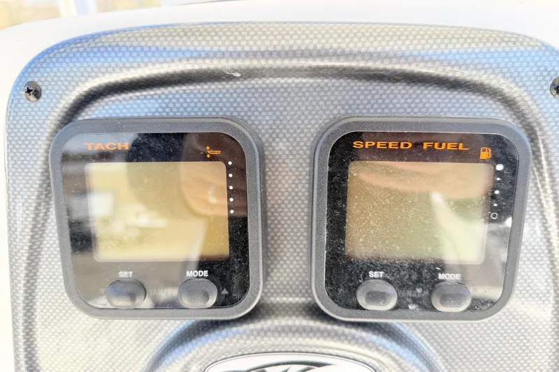 Slide: The Image of Dashboard of a 2015 Tidewater 230 CC Adventure boat showing tachometer and speed fuel gauges. - 14