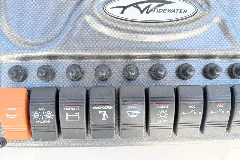 Slide: The Image of Control panel of a 2015 Tidewater 230 CC Adventure boat with labeled switches. - 16