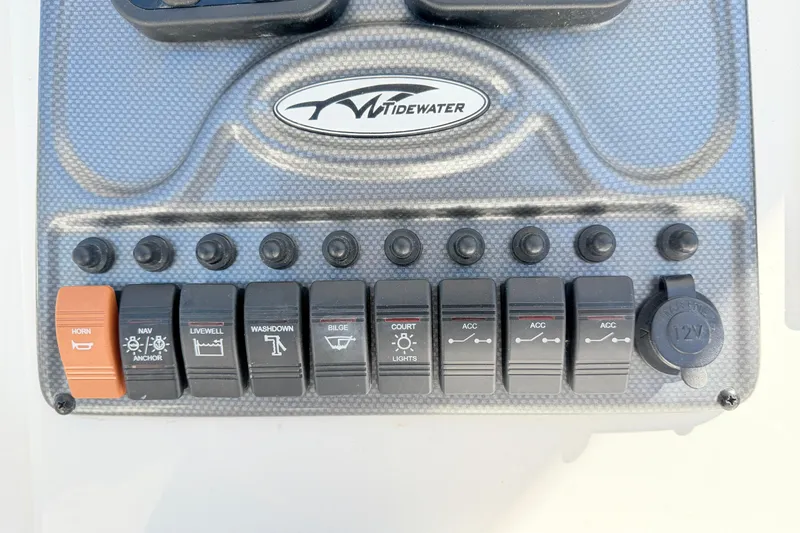 Slide: The Image of Control panel of a 2015 Tidewater 230 CC Adventure boat with labeled switches. - 18