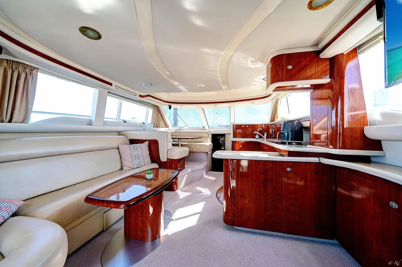 Slide: The Image of Luxurious interior of a 2004 Sea Ray 480 Sedan Bridge yacht with elegant wood finishes. - 13