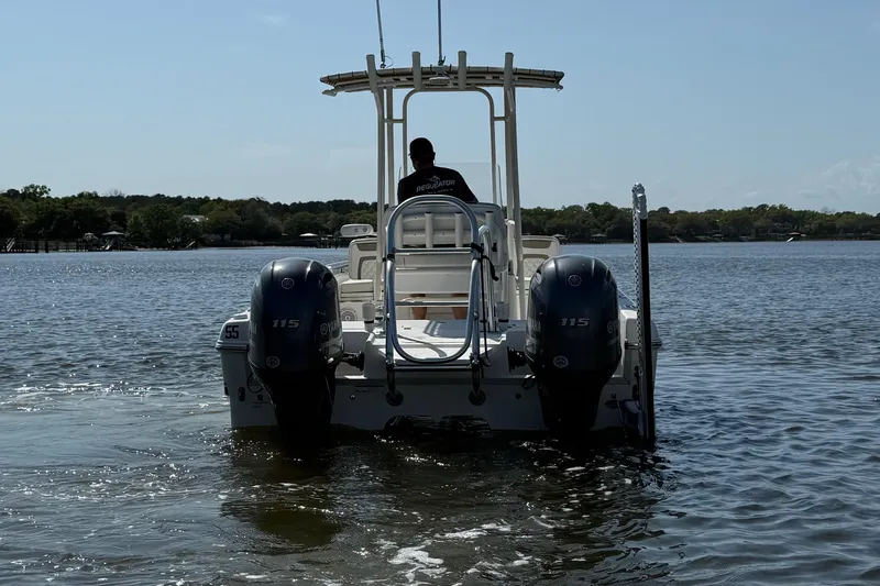Slide: The Image of 2019 World Cat 230 CC boat with dual engines on a calm lake. - 12