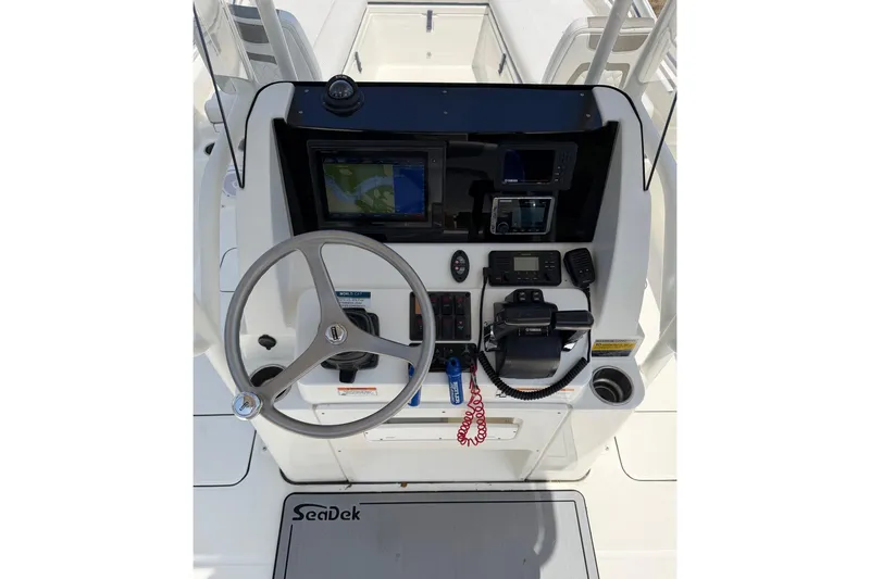 Slide: The Image of 2019 World Cat 230 CC boat console with steering wheel and navigation equipment. - 15