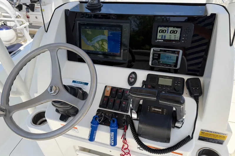 Slide: The Image of Control panel of a 2019 World Cat 230 CC boat with navigation and communication equipment. - 16