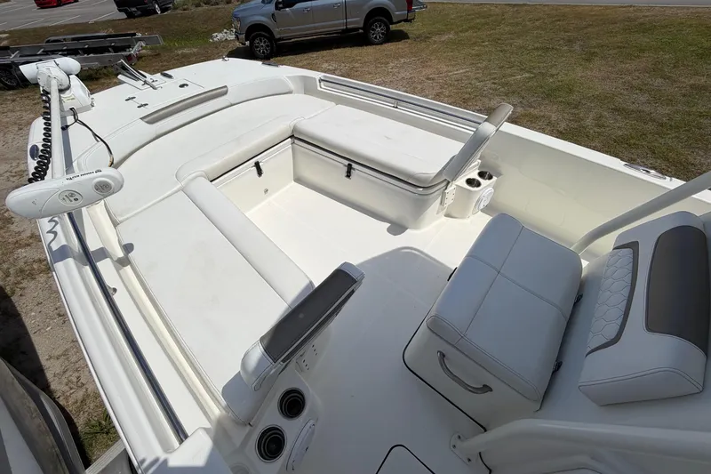Slide: The Image of 2019 World Cat 230 CC boat interior with white seating and storage compartments. - 19