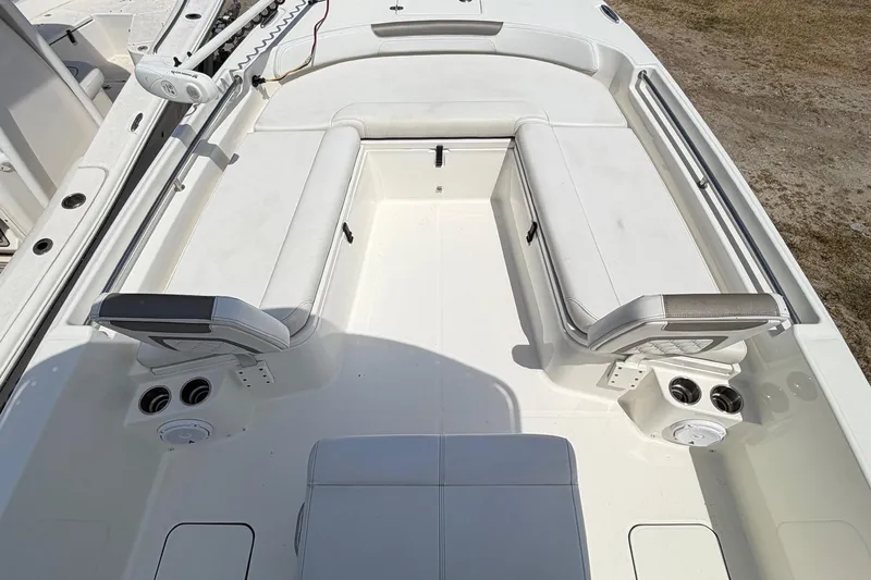 Slide: The Image of 2019 World Cat 230 CC boat interior with white seating and cup holders. - 21