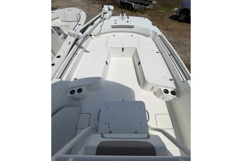 Slide: The Image of 2019 World Cat 230 CC boat interior with spacious deck and storage compartments. - 23